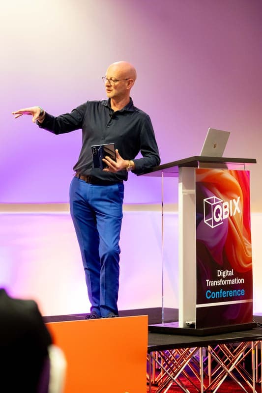 Andy Jarvis presenting beside the QBIX podium
