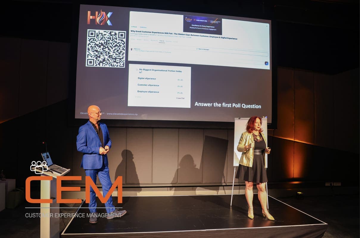 Andy Jarvis on stage beside a QR code slide